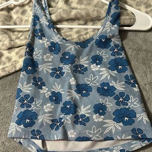 Crop top. Has a open back. Has flowers on it. Really cute.